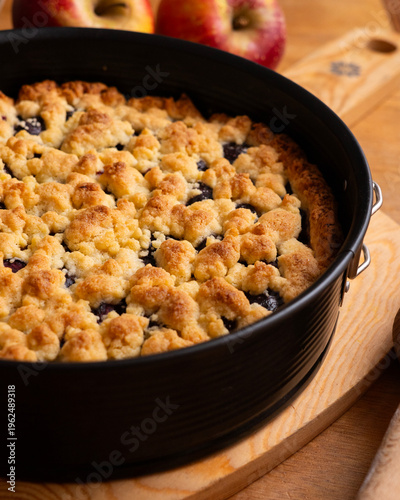Принти на полотні Delicious homemade cherry crumble pie with fresh mint garnish on a wooden board