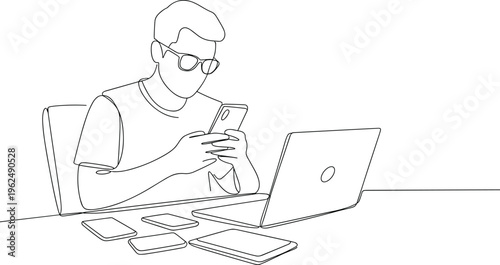 Man in white shirt and glasses reading newspaper at wooden desk with laptop des