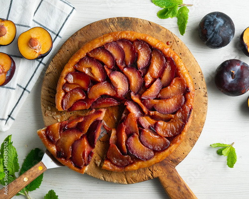Delicious tatin plum tart with caramelized fruit and golden crust, ready to serve