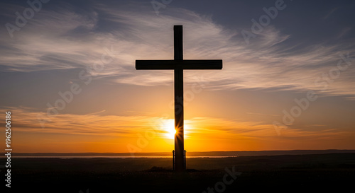 Silhouette of a Christian cross against a dramatic sunset sky symbolizing faith hope and spirituality perfect for religious themes and concepts