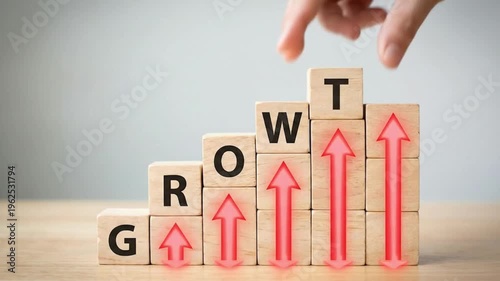 Hand placing wooden growth arrow blocks on rising success chart for business strategy concept