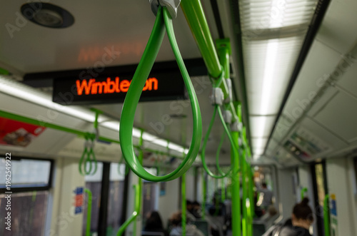 Green handles inside train with Wimbledon sign