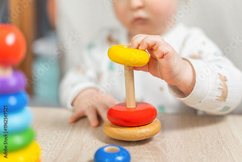 Child Playing with Colorful Stacking Toy at Home