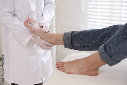 Canvastavla Doctor applying talcum powder onto man's foot in clinic, closeup
