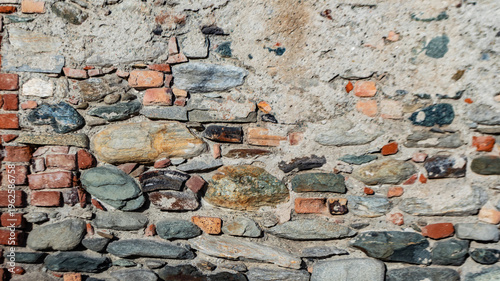 Historic rustic wall made of stones and bricks, authentic architectural texture ideal for design backgrounds, restoration themes and heritage projects