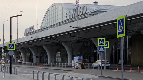 MOSCOW, VNUKOVO - SEP 18, 2025: Large airport terminal with a sign. The terminal is empty and quiet. There are no people or vehicles visible