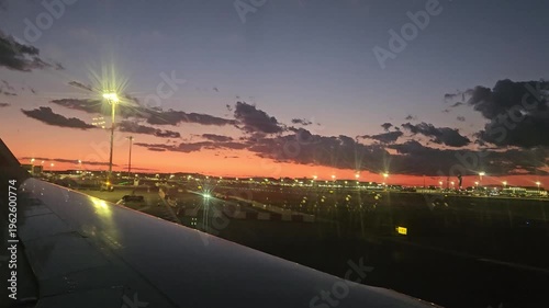 ISTANBUL - SEP 18, 2025: Beautiful sunset over a city with a large airport in the background. The sky is filled with clouds and the sun is setting