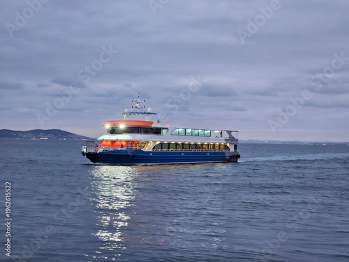 Wallpaper Mural Large blue boat is sailing on the water. The sky is cloudy and the water is calm Torontodigital.ca