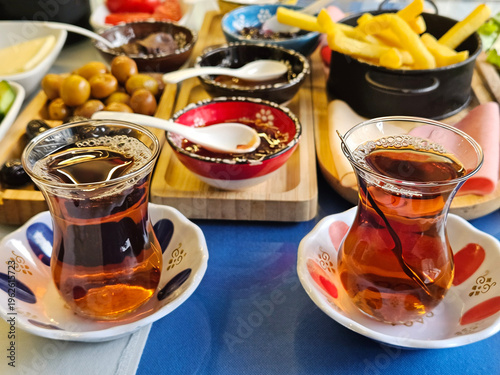 Wallpaper Mural Table with a variety of food and drinks, including two cups of tea. The table is set for a meal, and the cups of tea are placed in the center of the table Torontodigital.ca