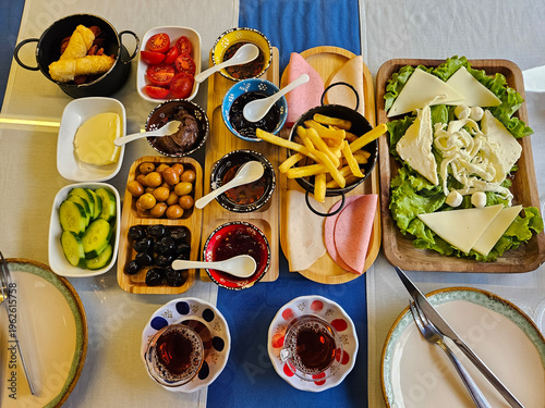 Wallpaper Mural Table with a variety of food items, including a salad, a bowl of soup, and a plate of meat Torontodigital.ca