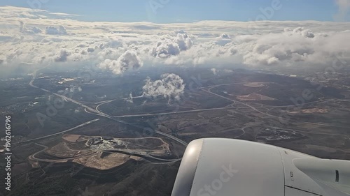 Wallpaper Mural The sky is cloudy and the plane is flying through it. The clouds are white and fluffy Torontodigital.ca