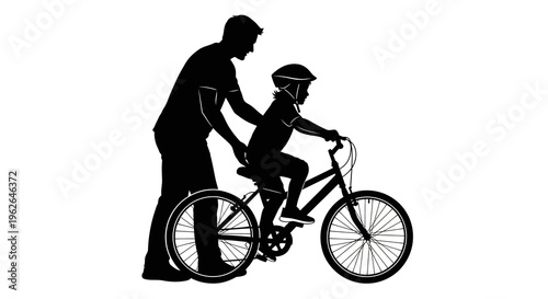 Man helping child learn to ride a bicycle with support