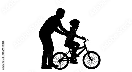 Father teaching son to ride a bike with support