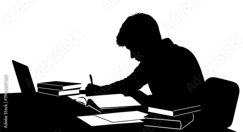 Man sitting at desk with laptop and books studying hard
