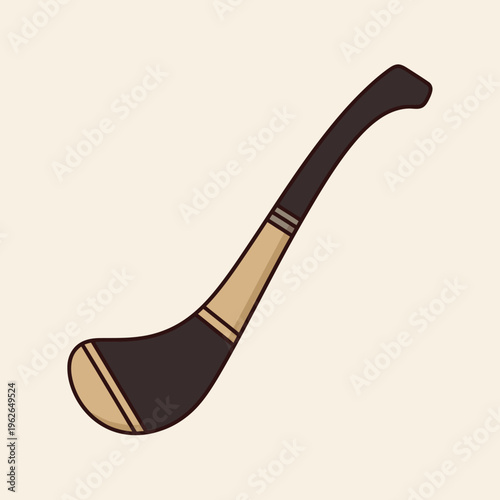 A close-up image of a traditional Hurling stick, known as a hurley, on a light-colored background