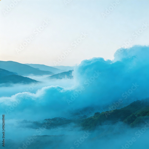 Misty mountain range with turquoise clouds and hazy peaks under a soft, light sky. Lush green hills emerge from dense fog, creating a serene and tranquil natural landscape.