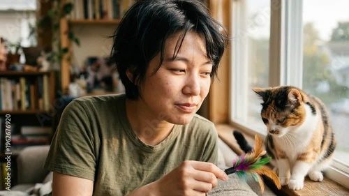 Woman smiling gently while working indoors by a window