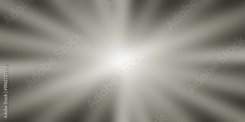 Tableau sur toile A bright light shines in the center of a gray background with rays of light eman
