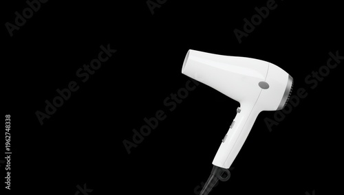 Compact white hair dryer on black background, ideal for travel