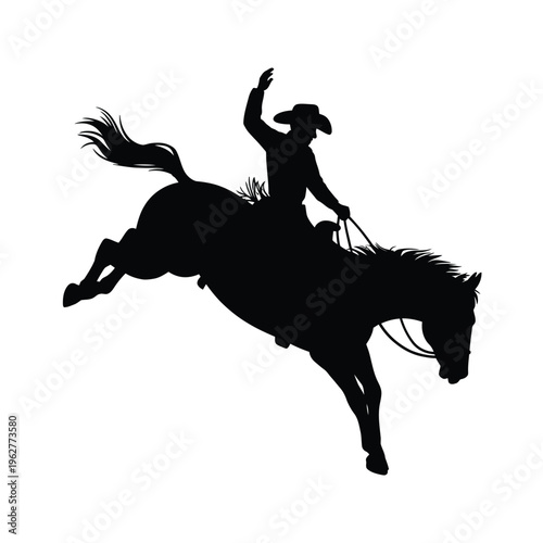 Silhouette of a cowboy riding a bucking horse in a dynamic pose
