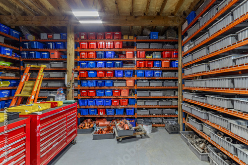 Organized Industrial Workshop Storage with Color-Coded Bins and Shelving System