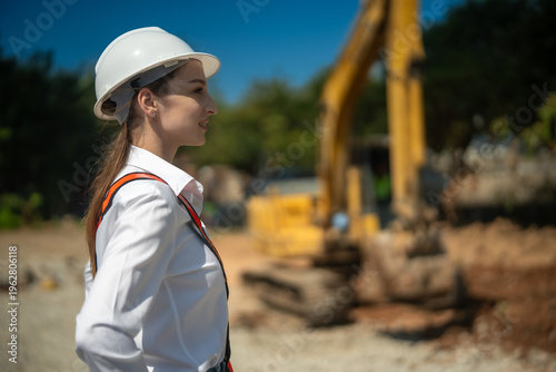 Female engineer hard hat construction site excavator safety project management infrastructure, confident professional overseeing work with calm focus and steady determination