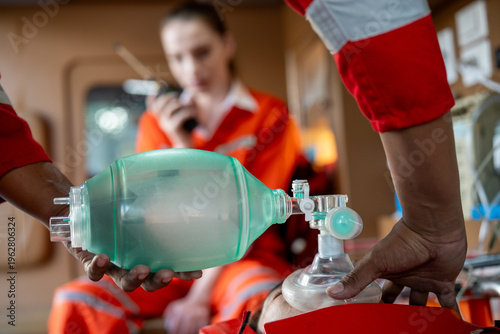 Emergency paramedic rescue ventilation airway oxygen CPR medical ambulance mask in use, careful hand seals face mask, urgent care inside ambulance, steady focus pressure drive lifesaving action