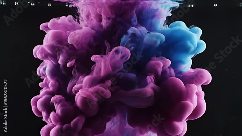 Swirling magenta and cyan clouds of ink in dark water create a dynamic abstract form