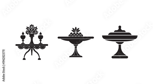 Black silhouettes of candelabra fruit bowl and covered dish on white background