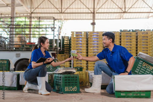 Modern farmer asian agriculturists working inspection mango packing warehouse. Random inspection food security traceability innovation agribusiness strategy food chain industry.