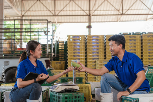 Modern Asian agriculturists export mango packing warehouse. Male farmer officer send mango to female random inspection food security traceability innovation agribusiness strategy food chain industry.