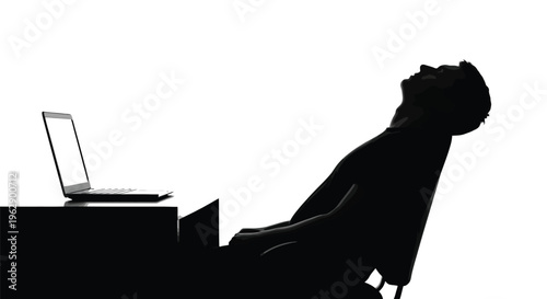 Young man's silhouette leaning back from his laptop contemplating future success