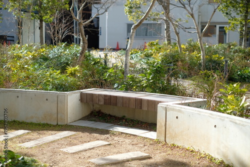 Εκτύπωση καμβά Small new park with integrated wooden bench and raised flower bed edging