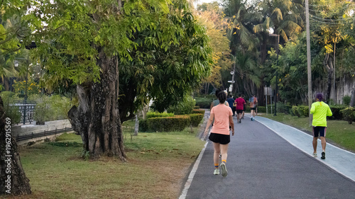 Life lifestyle thai people and fitness enthusiast training jogging and walk run exercise workout in Somdet Phra Srinagarindra Park or Suan Somdet Ya Public Garden at Pak Kret in Nonthaburi, Thailand