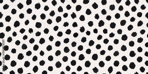 Abstract black brushstrokes scattered across a pale cream background