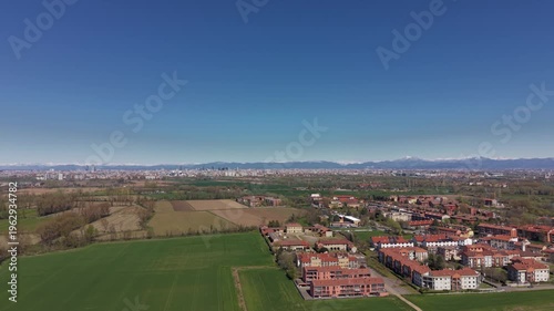 Urban Expansion into Rural Landscape: An aerial view captures the gradual encroachment of urban development onto a verdant countryside.