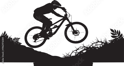 Black silhouette of mountain biker jumping over cliff with plants