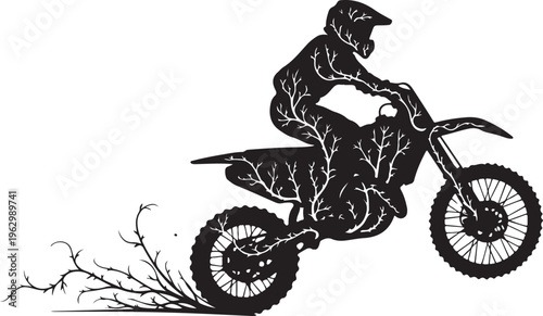 Black silhouette of a person riding a dirt bike kicking up dirt