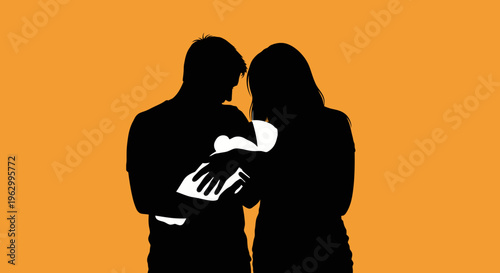 Silhouette of couple holding baby.
