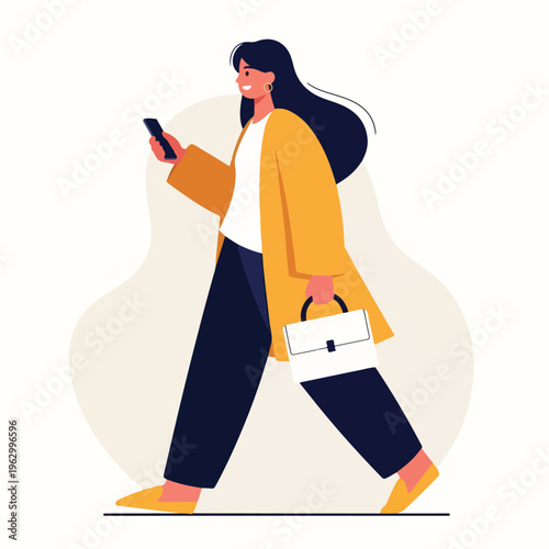 A woman in a coat walks with a bag while looking at her phone