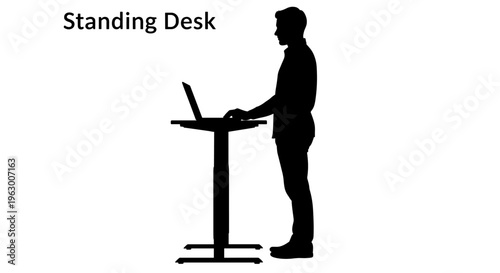 Man working on standing desk.