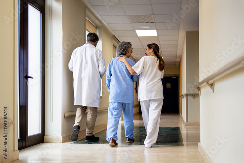 Doctors attending to a patient in a hospital corridor