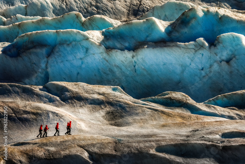 Photos A small group of unrecognisable hikers Crossing the vast Mendenhall Glacier , Al