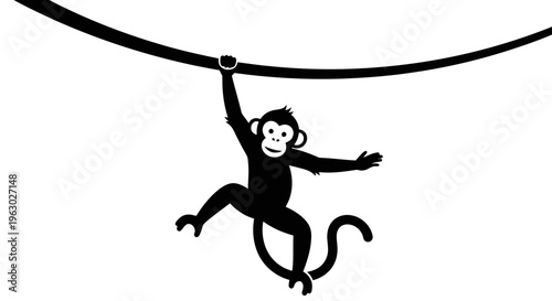 Silhouette of a playful monkey swinging on a vine.