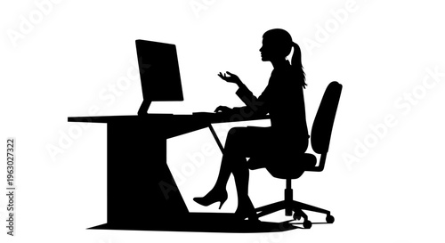 Silhouette of a Woman Working at a Computer Desk.