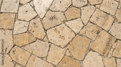 Cream irregular stone patio with organic flagstone pieces and natural pores, paver patterns in top view for rustic outdoor flooring reference, limestone texture background, sunlit surface