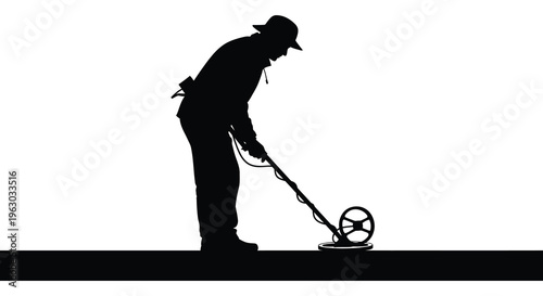 Man using a metal detector shown in striking black silhouette
