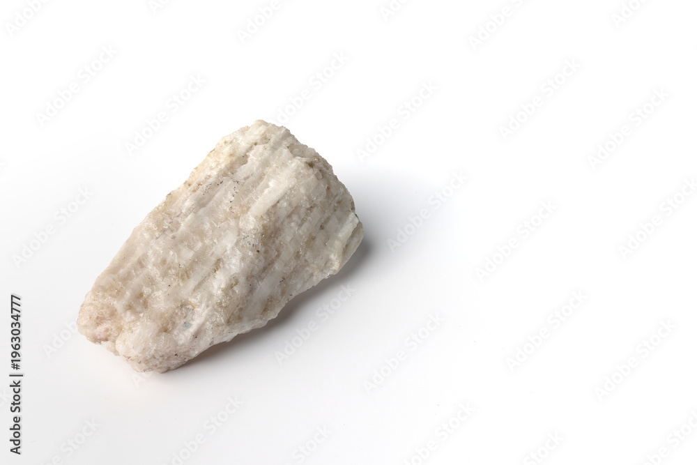 Obraz premium Lithium ore, hard rock spodumene. Isolated on white background. Critical battery mineral, raw material. Mine, mining, natural resources. Copy space