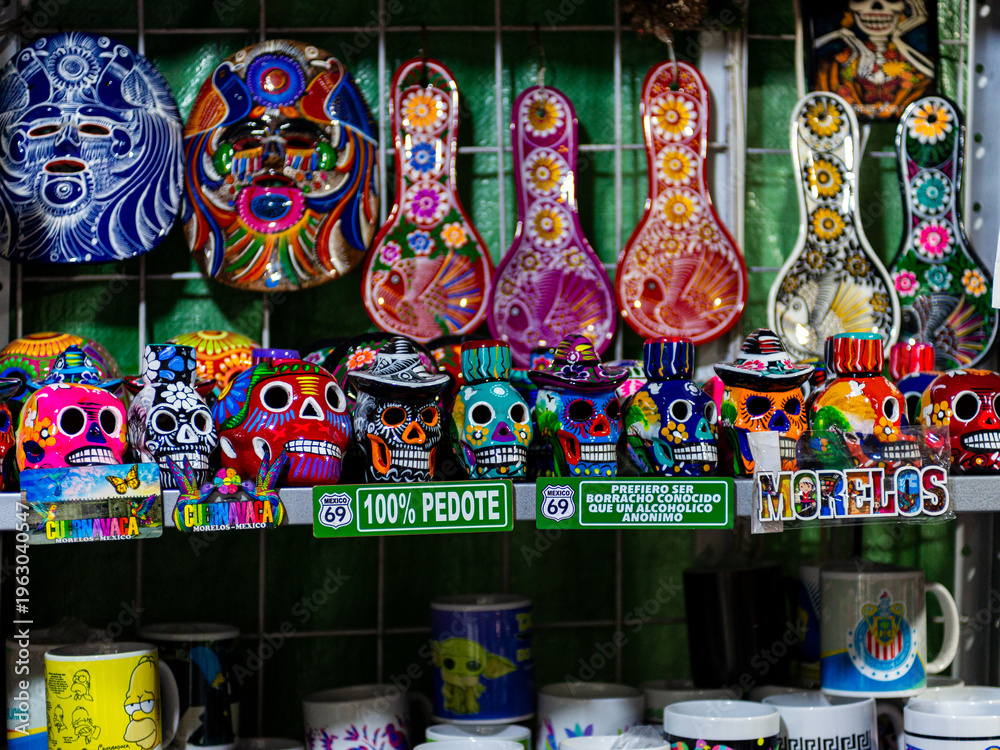 Fototapeta premium Vivid Traditional Mexican Art Display Featuring Sugar Skulls and Decorative Masks