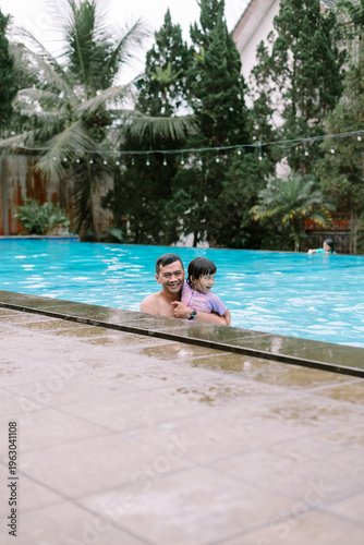 Obraz na płótnie Smiling Father and Daughter Swimming on Sunny Day